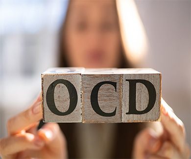A female holding the OCD blocks