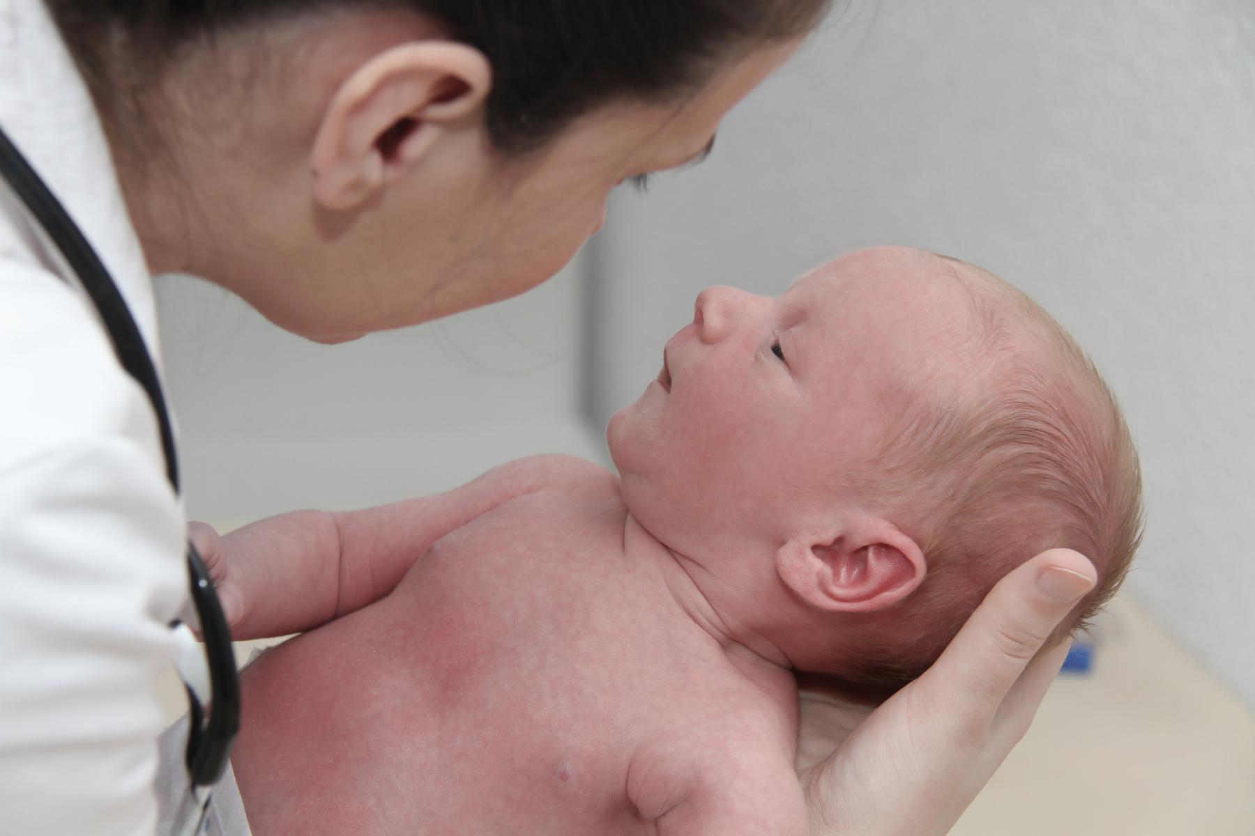 Nurse holding infant